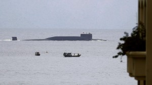 In this Aug. 28, 2014 photo, fishermen look at a Chinese nuclear submarine sails past...