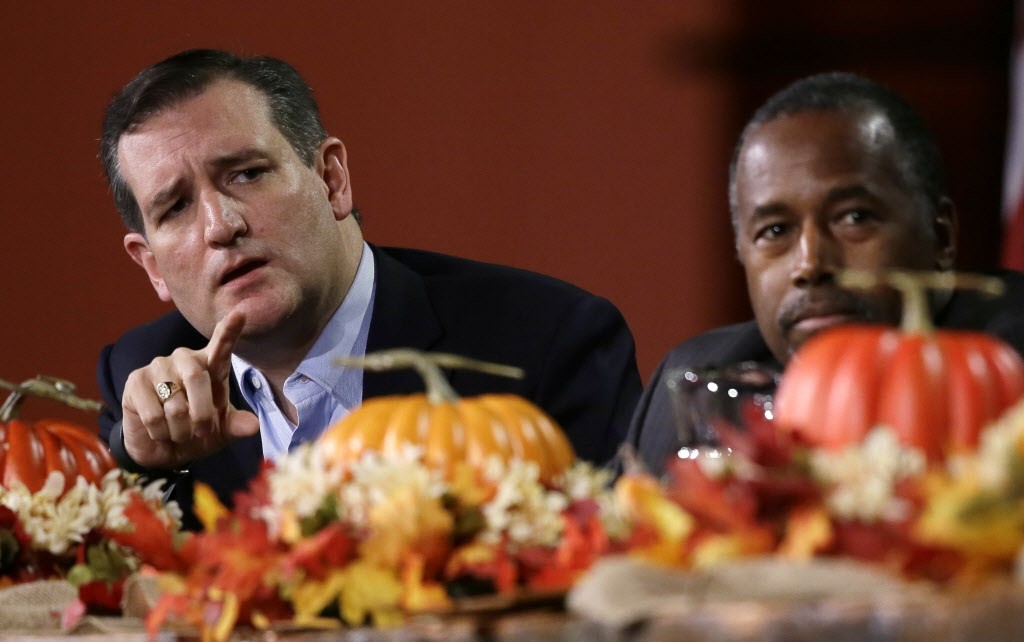Republican presidential candidate, Sen. Ted Cruz, R-Texas, left, speaks during the Presidential Family Forum as Ben Carson listens, Friday, Nov. 20, 2015, in Des Moines, Iowa. (AP Photo/Charlie Neibergall)