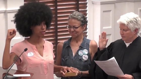 Radical Georgia Commissioner Takes Oath of Office With Black Power Fist And Hand On Malcolm X Bio
